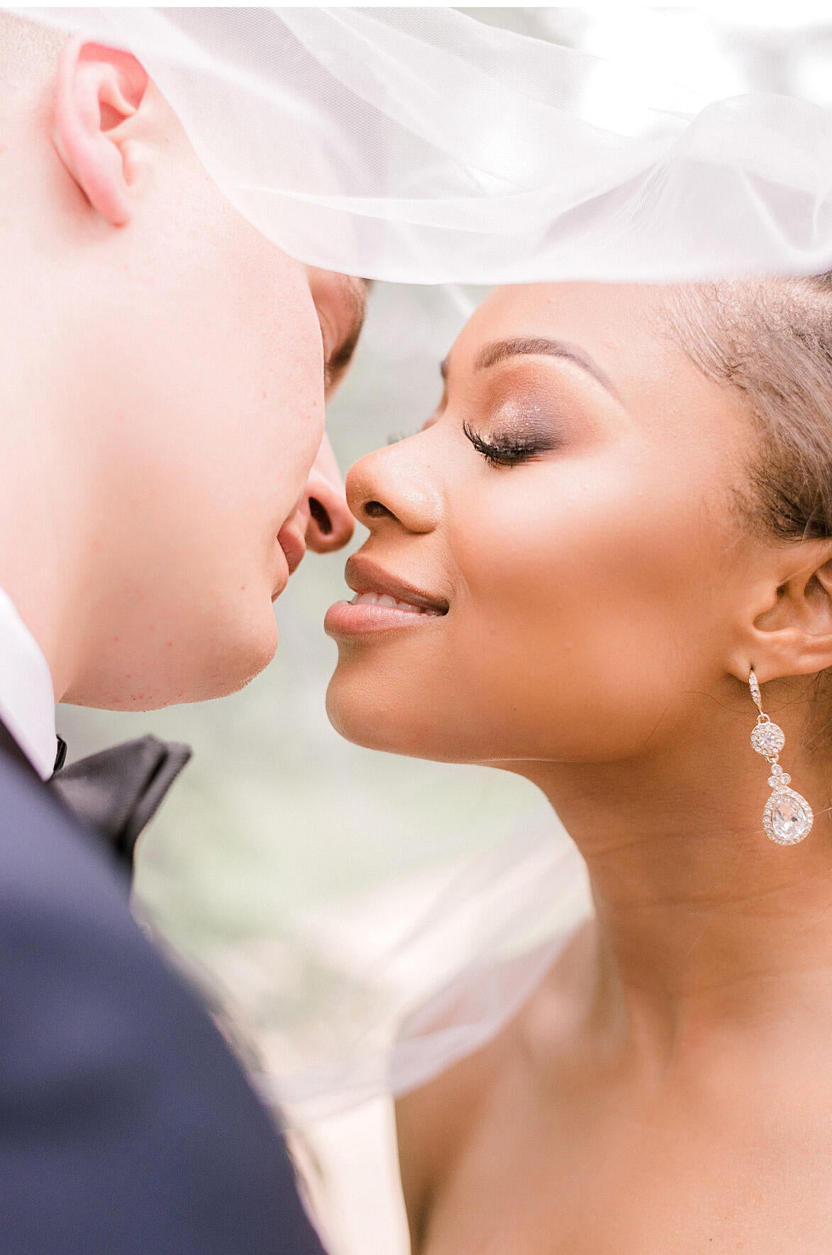 anastasia gentry image of couple kissing close up under veil