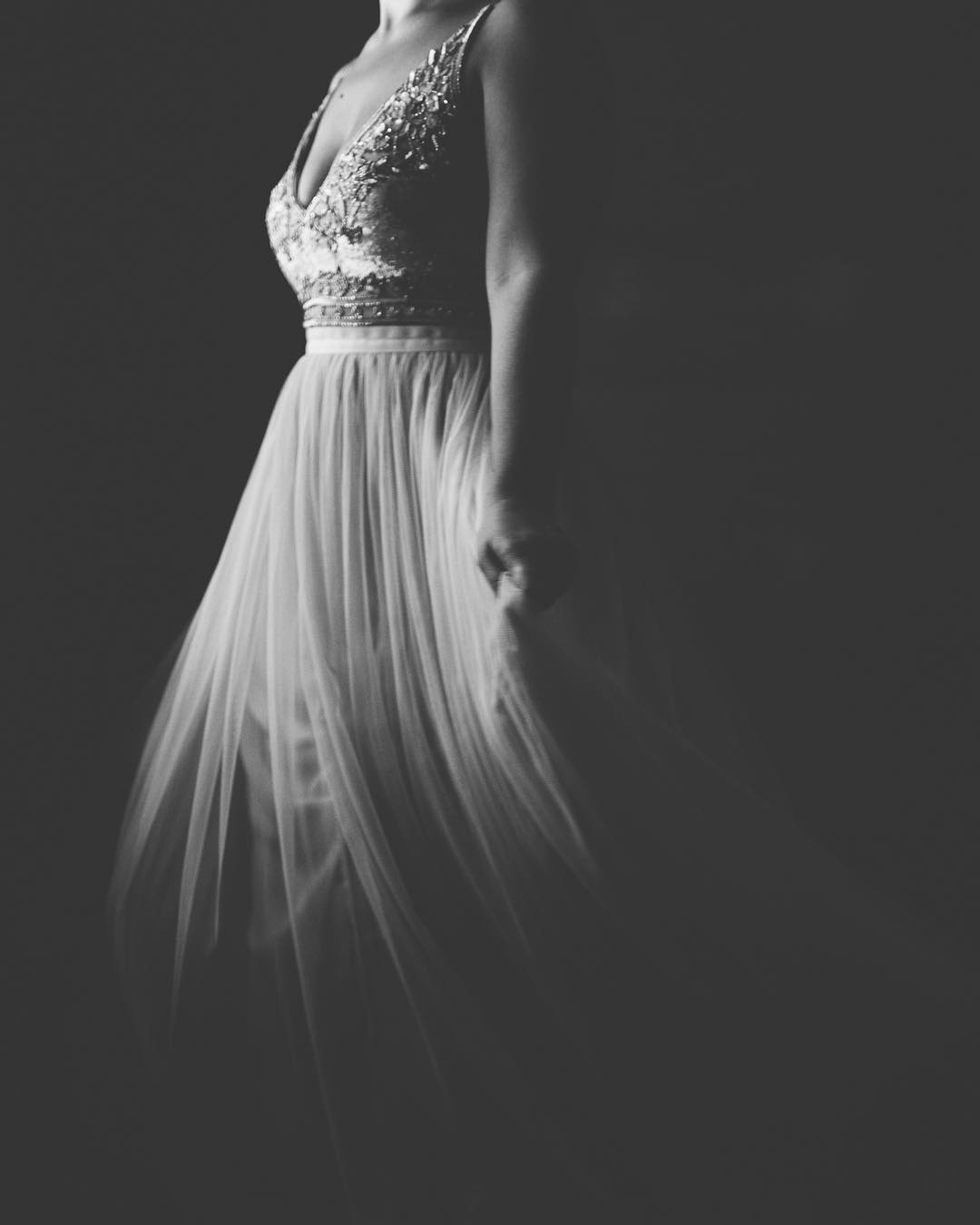 A black and white image of a bride wearing wedding dress