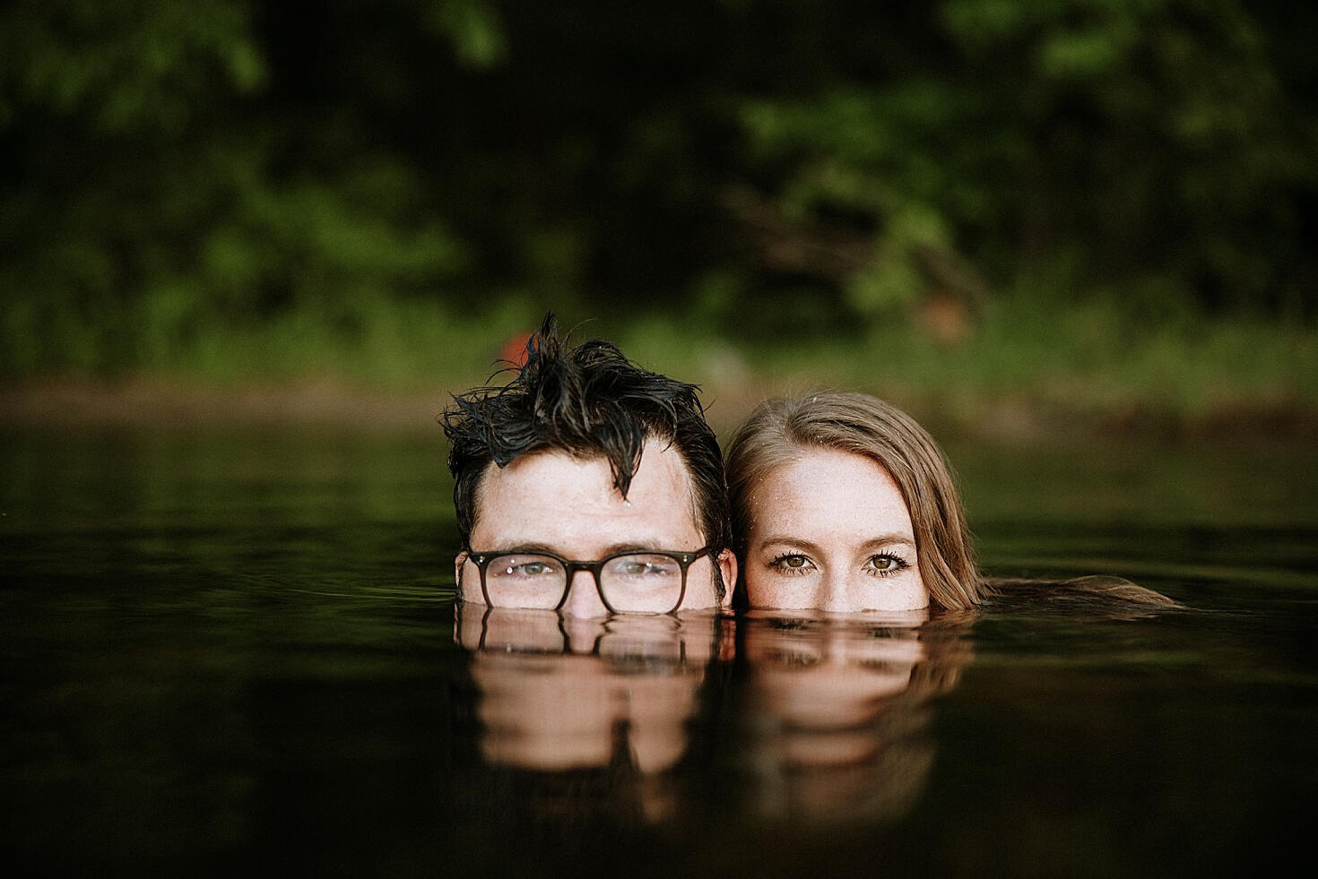 couple in water with reflection