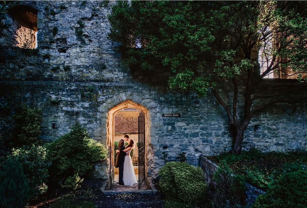 couple in old house doorway lit from behind