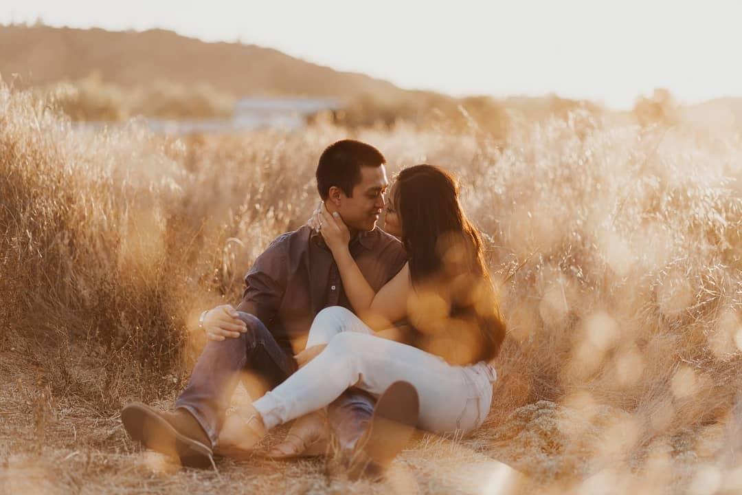 A couple sitting outdoor and looking at each other