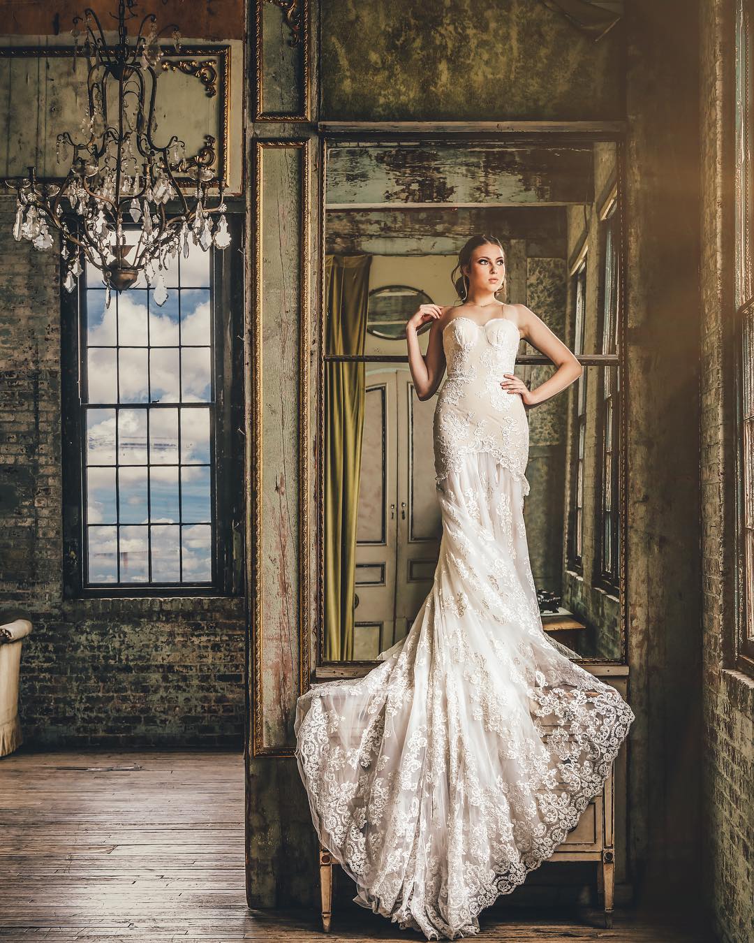 A bride posing in front of a vintage looking background  