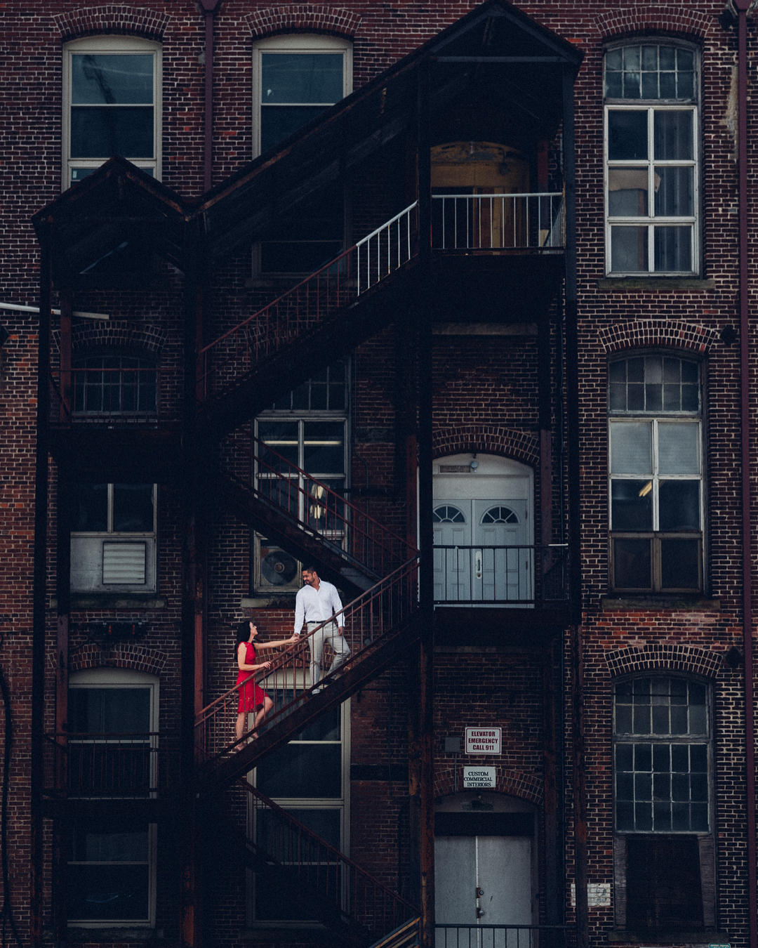 Wonderful engagement shot of a couple on a fire escape. 