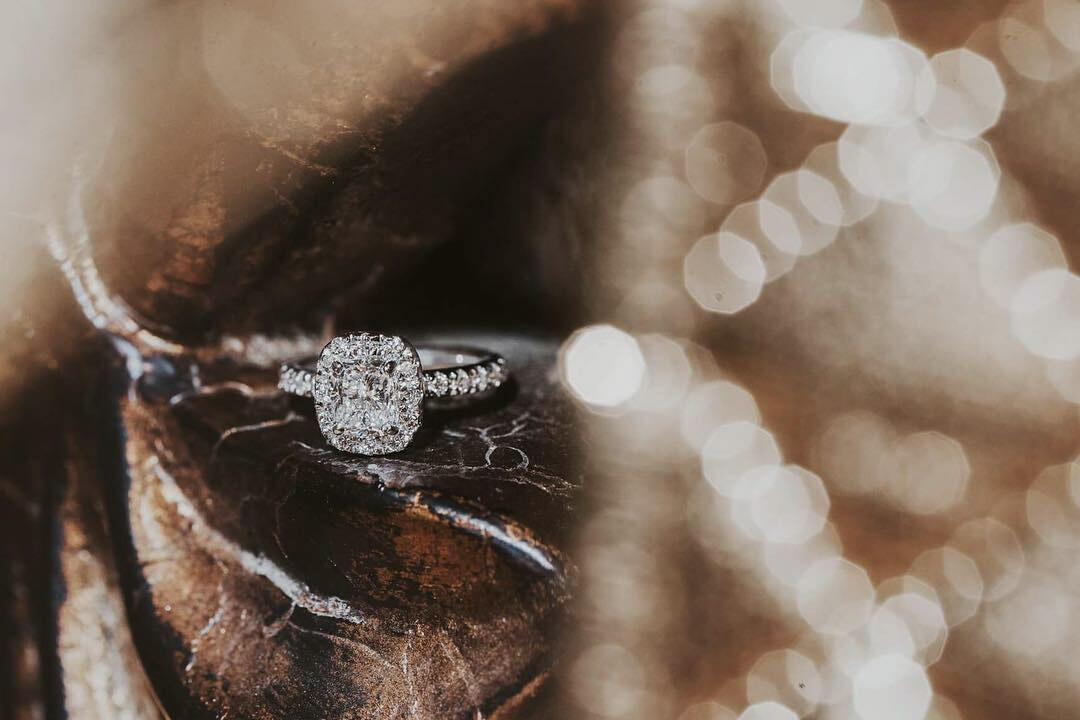 A princess-cut ring with a bokeh effect background