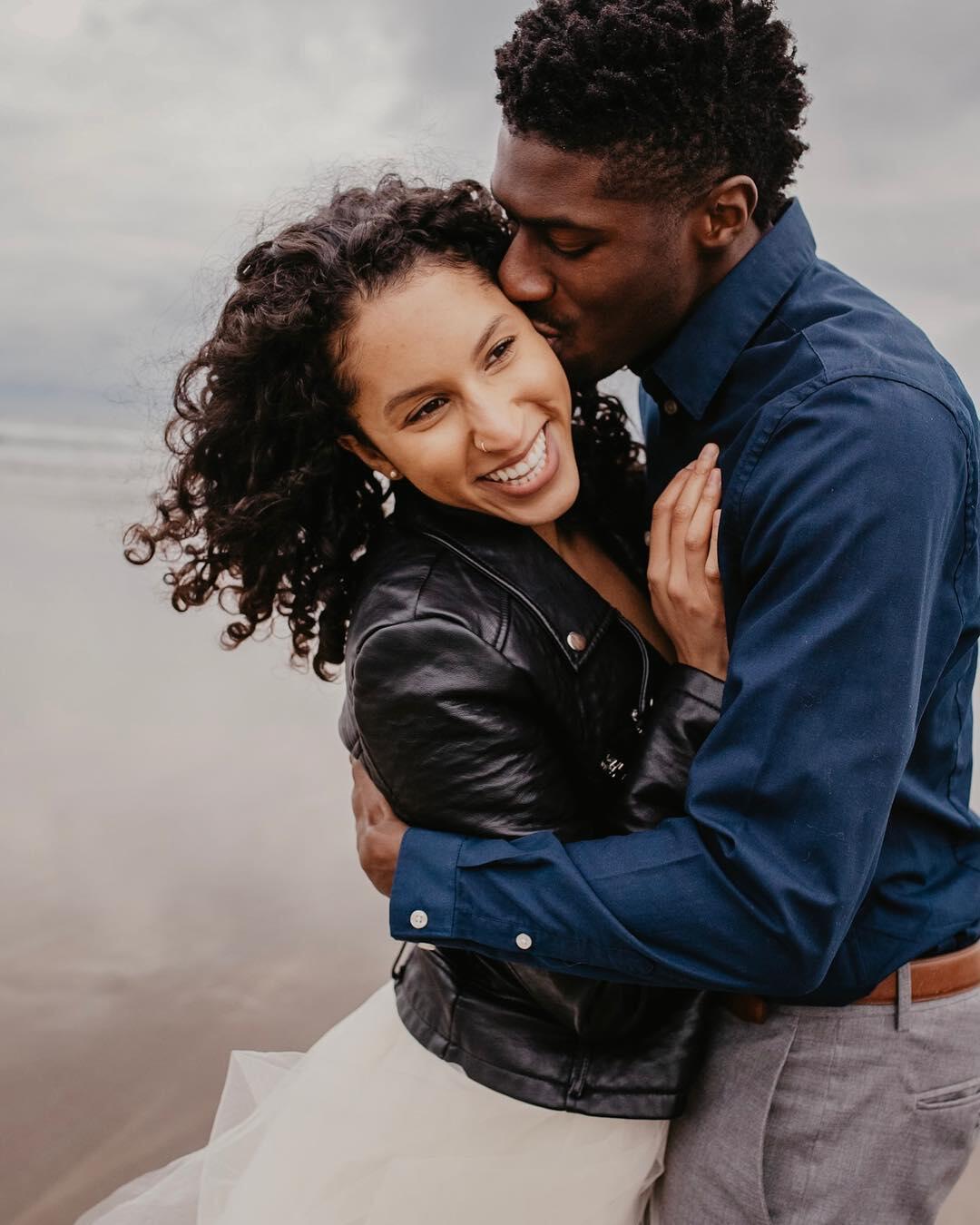 black couple dancing and kissing during their engagement session