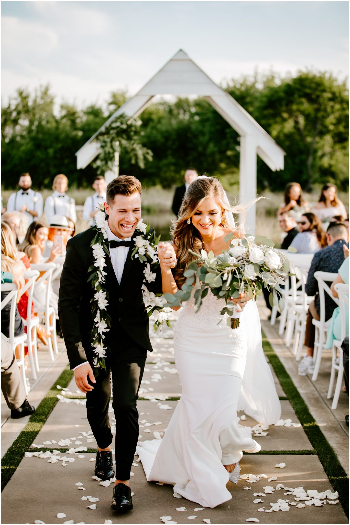 A bride and groom walking hand in hand as they make the exit after the wedding ceremony 