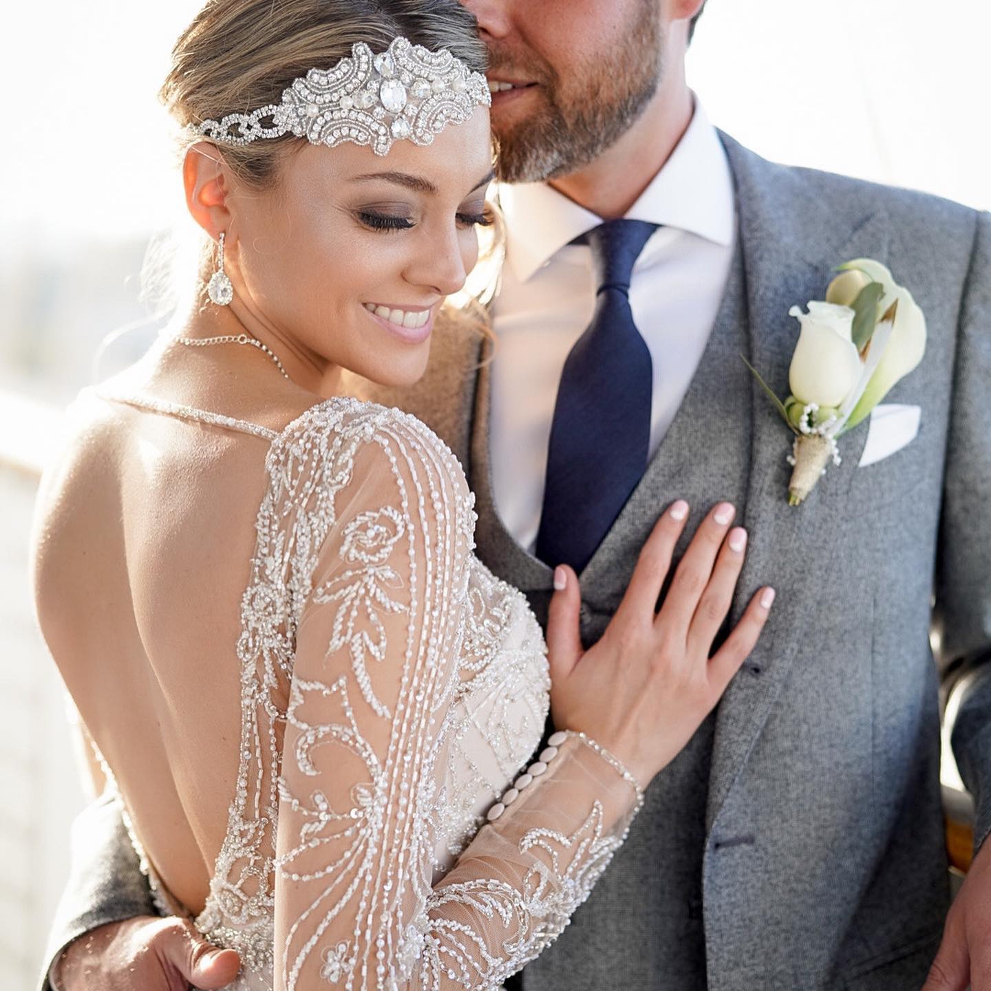 Portrait of a bride and groom hugging each other from the point of view of over the bride's shoulder