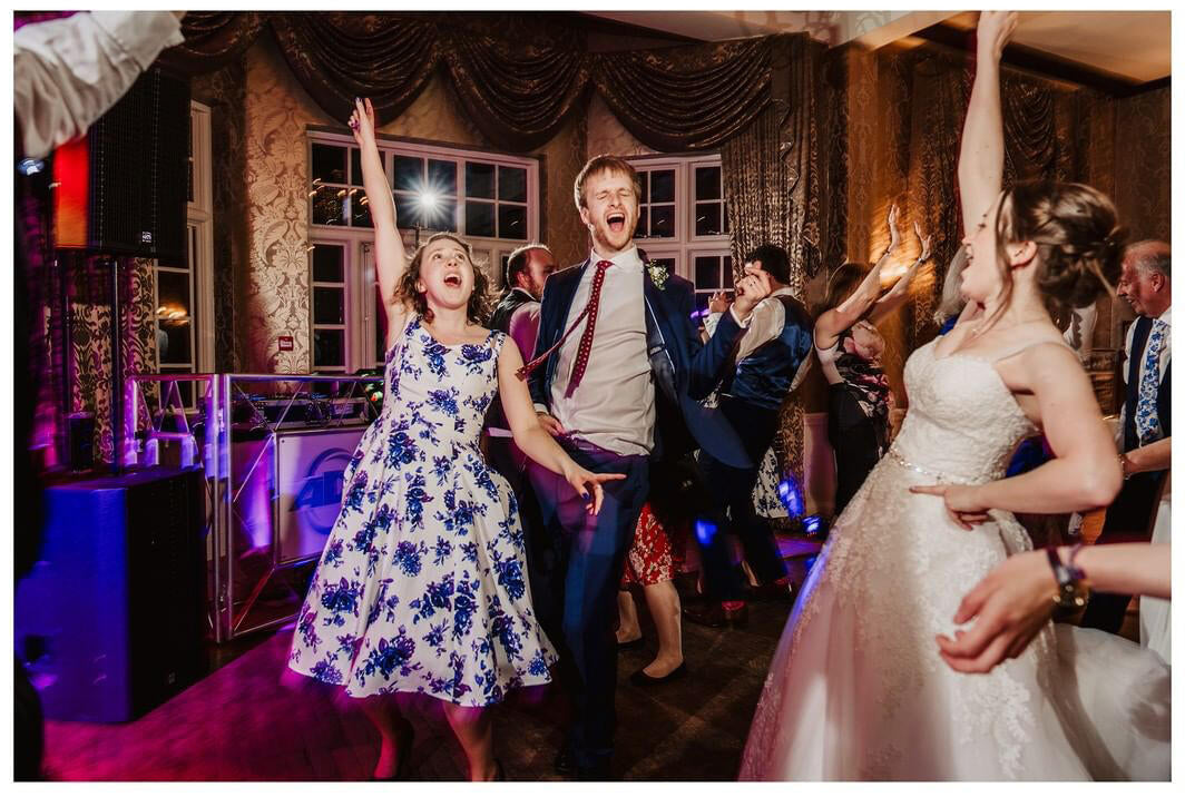 people dancing with bride on dance floor