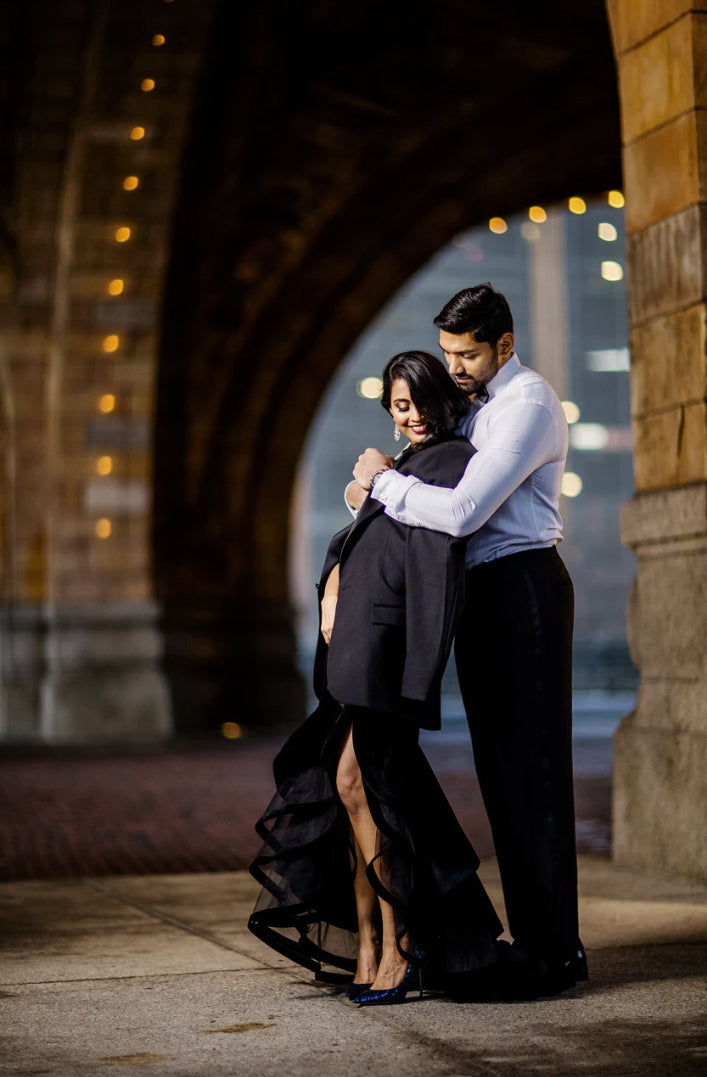 A portrait of a couple posing at night