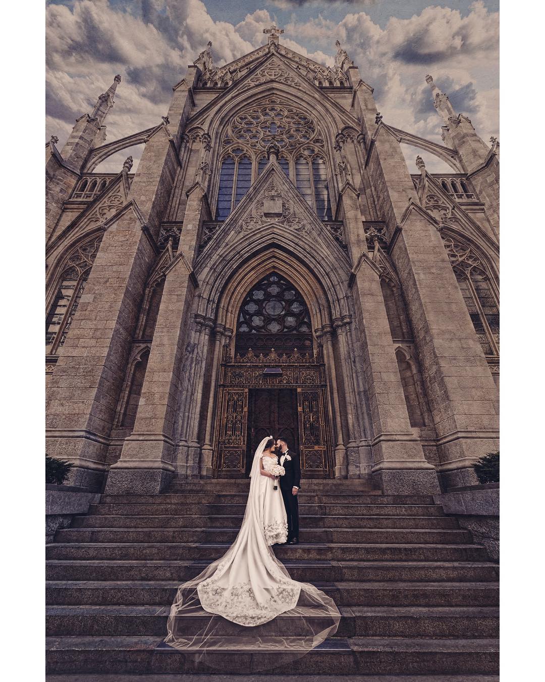 A bride and groom posing at the stairs (a scene from a high-end weddings)