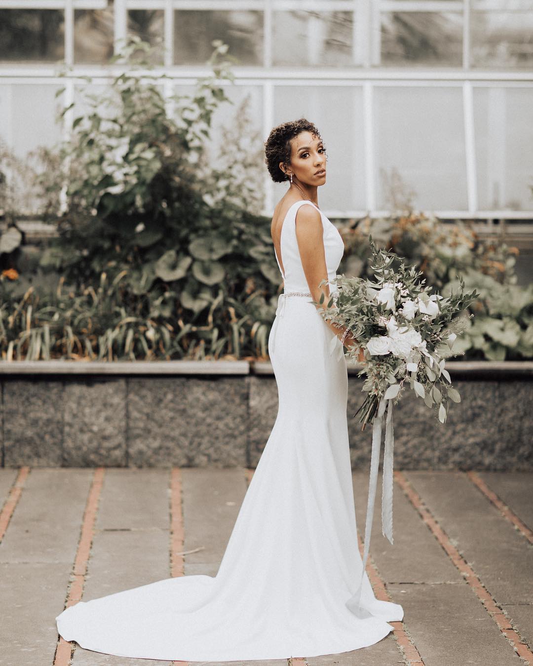 A bride posing while holding her bridal bouquet