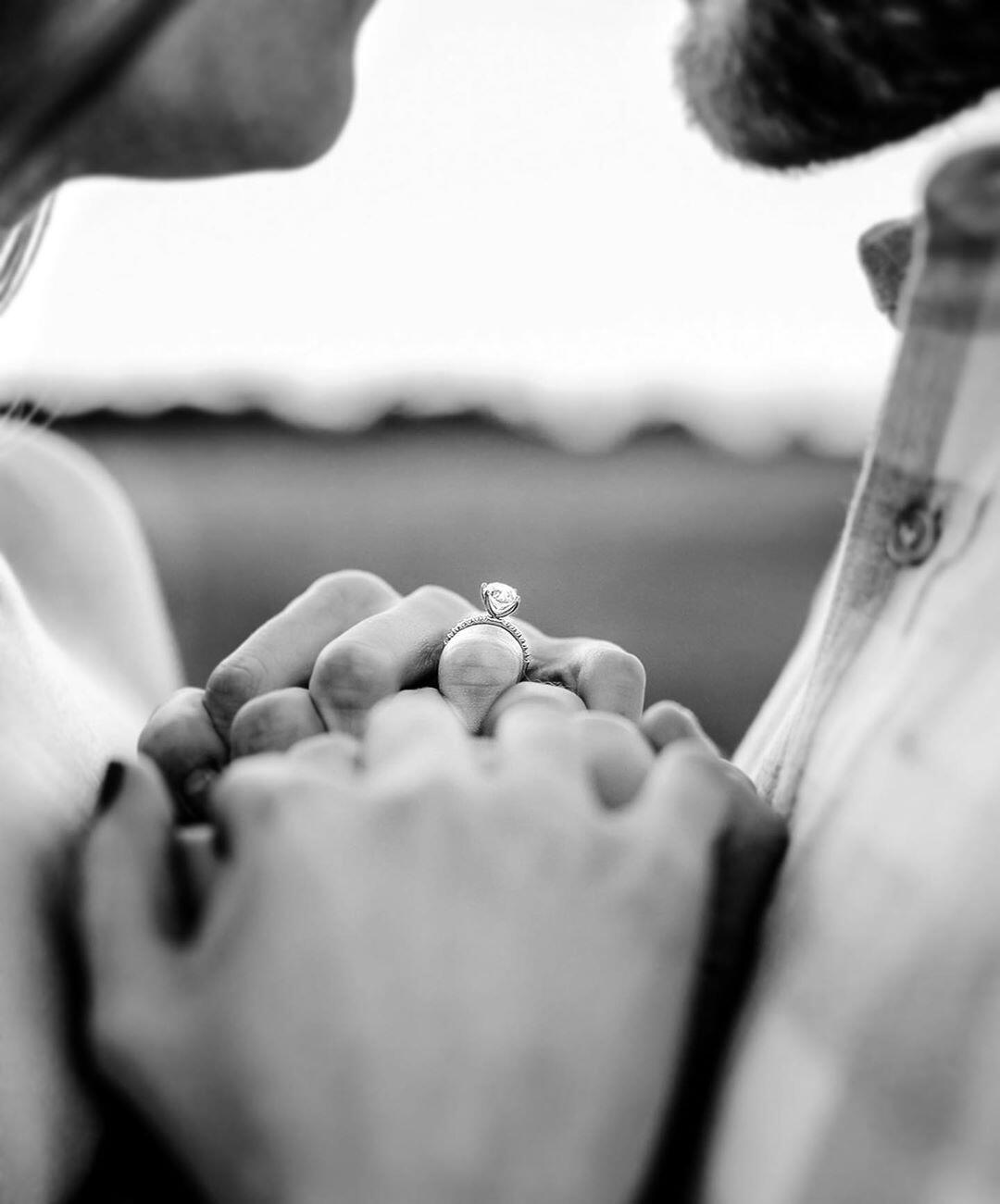 close up of engagement ring in black and white