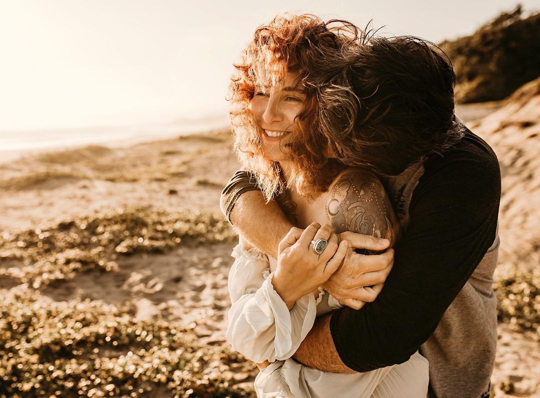 A couple portrait displaying a guy hugging his partner