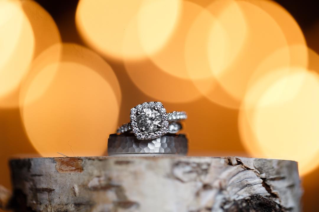 Close up shot of a diamond ring with yellow bokeh background 