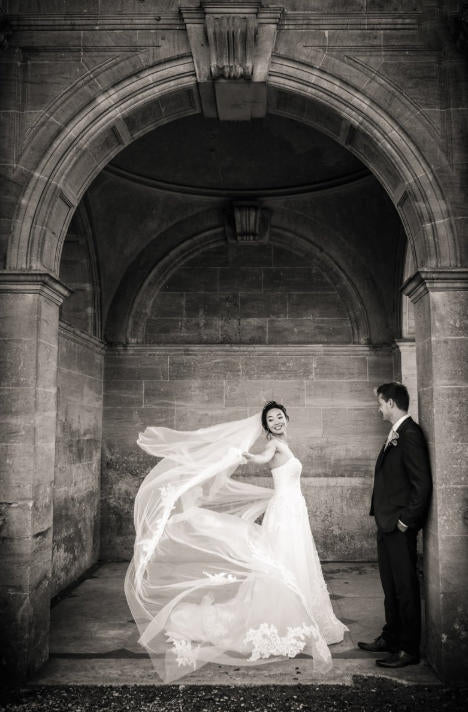 A stunning wedding photography shot of a bride and groom in an archway. by SDE customer