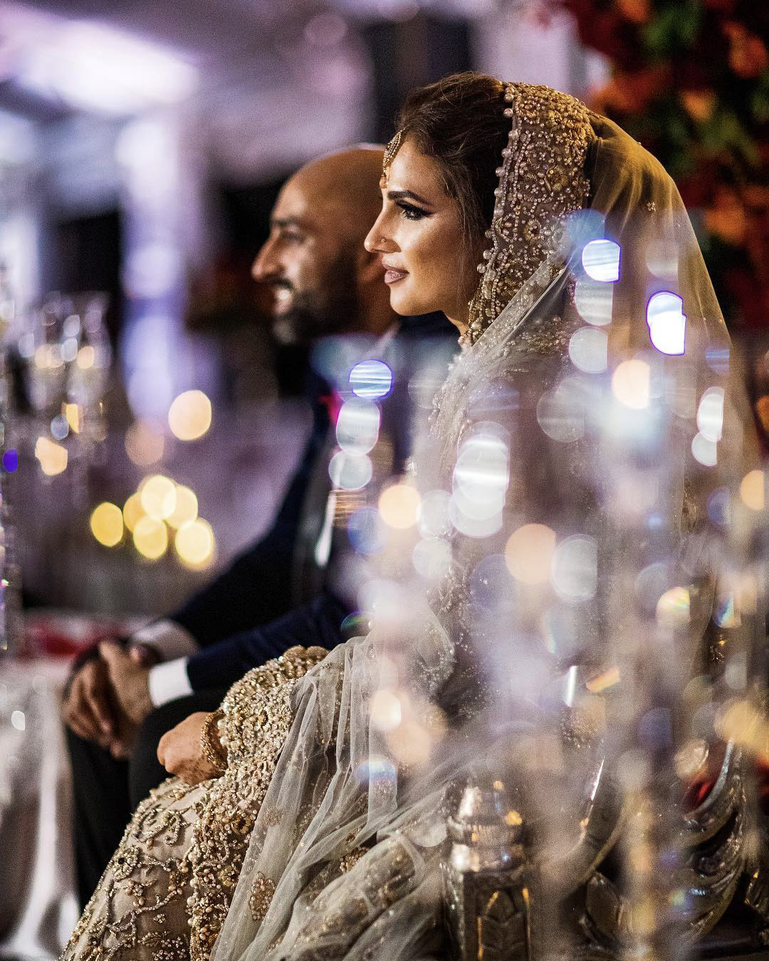 Portrait of an Indian couple seating with bokeh effect on the side