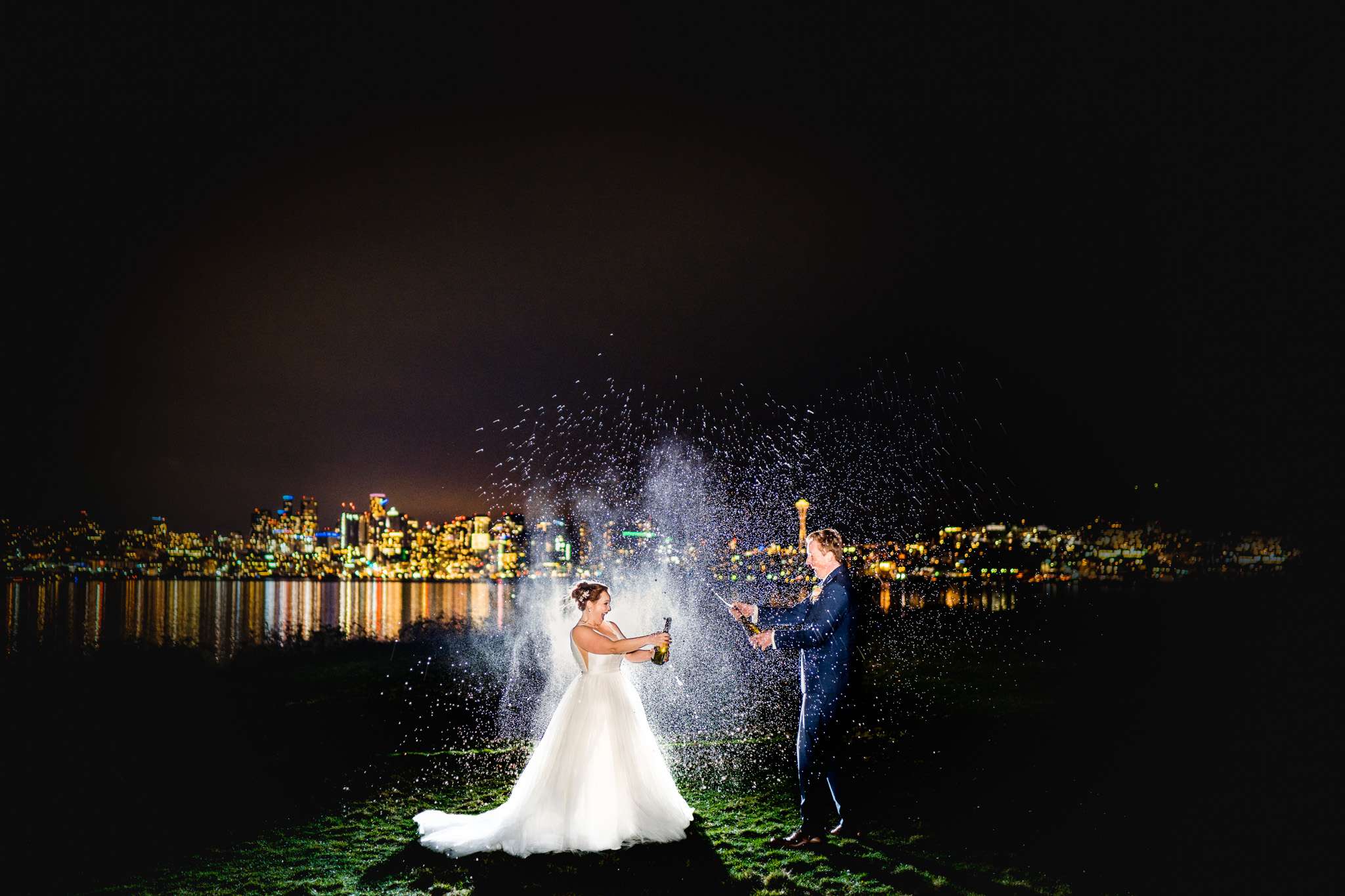 Bride and groom popping open the bottles of champagne