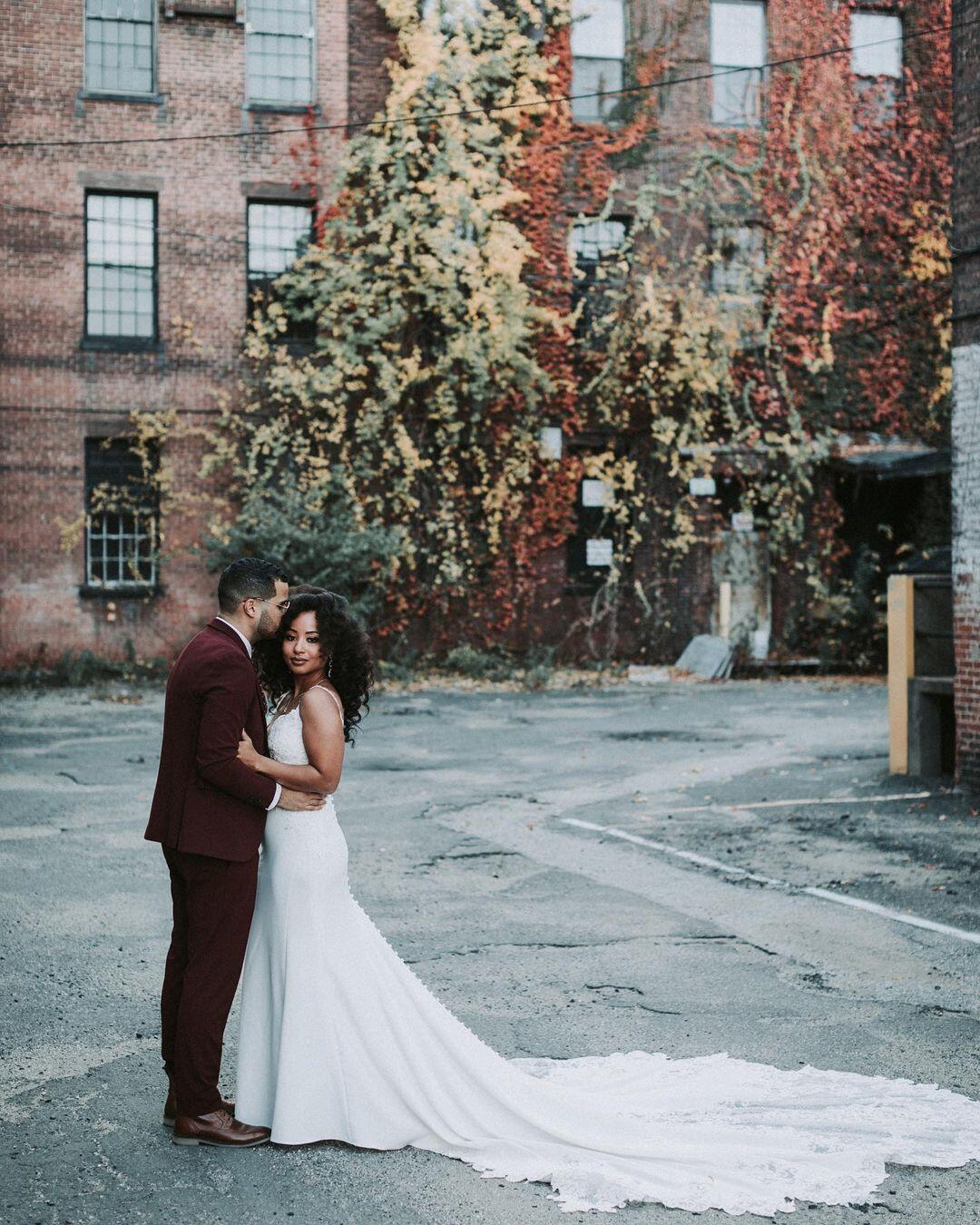 Bride and groom posing together while holding each other