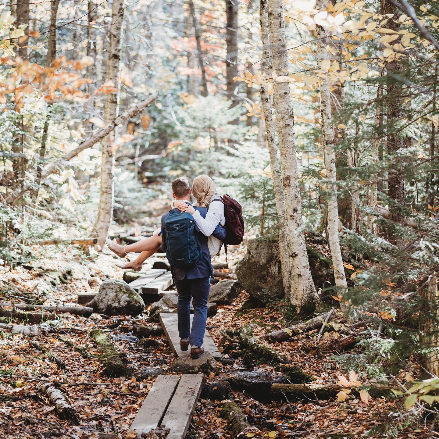 A couple posing as the guy walks while picking up the girl 