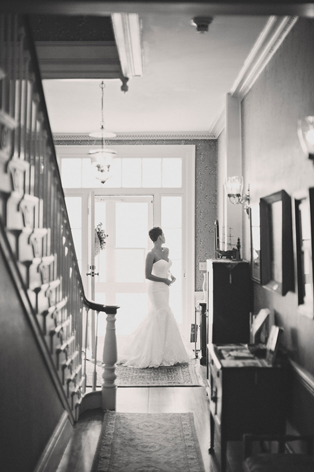 Black and white image of a bride in a hallway