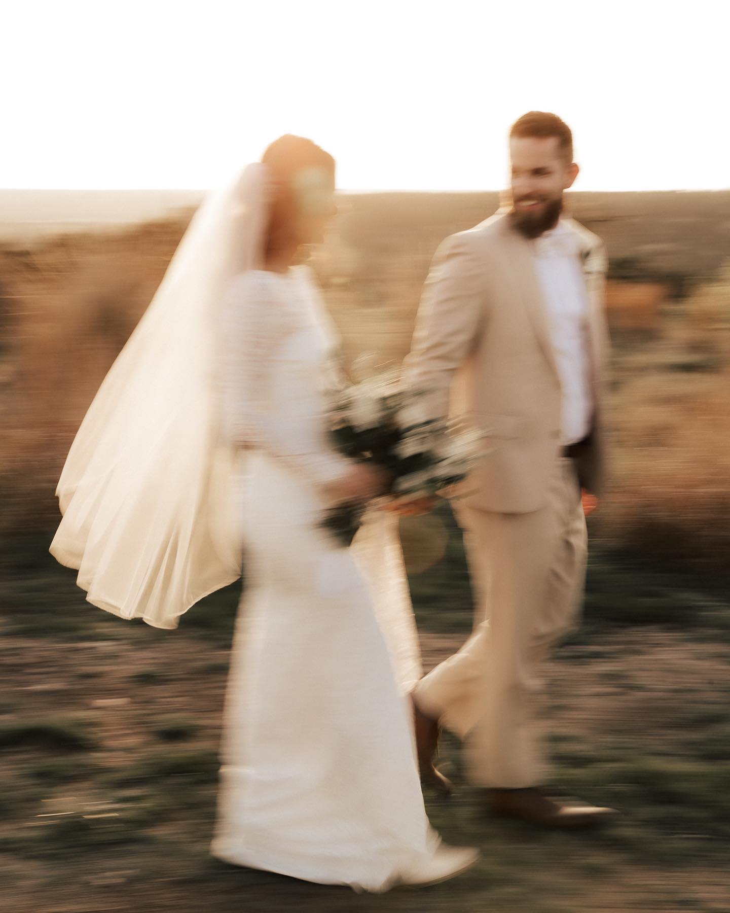 a couple in their wedding attire in motion