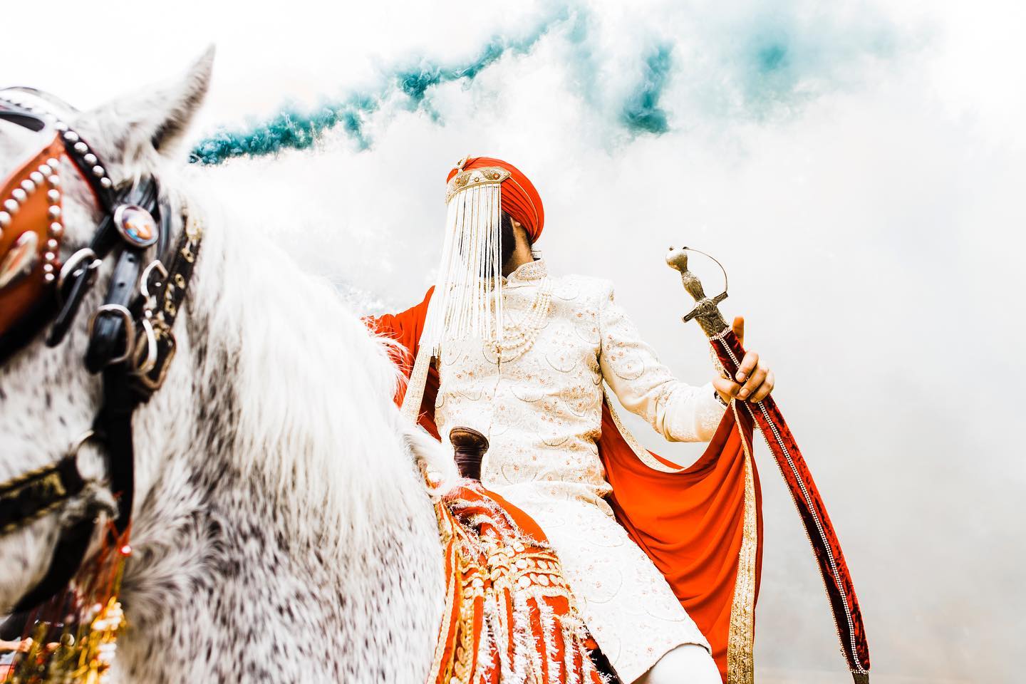 an wedding groom on a horse holding a sword