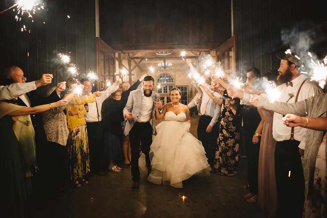 A couple doing a sparkler exit after the wedding reception 