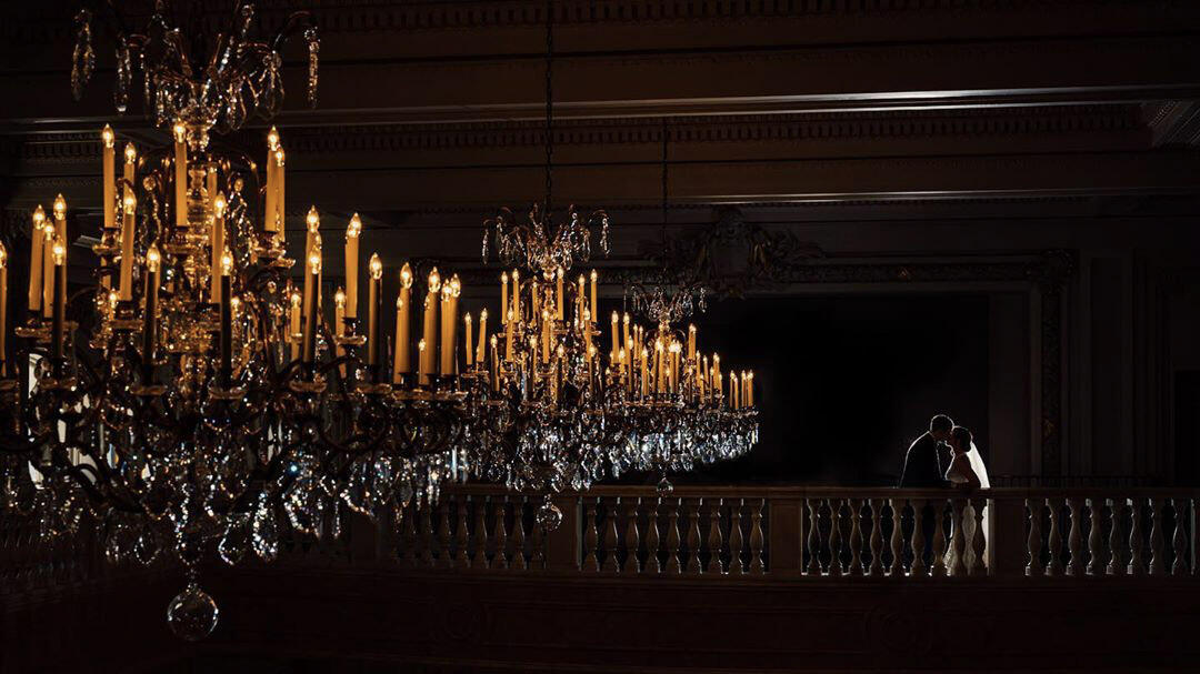 chandelier and couple kissing in silhouette with veil