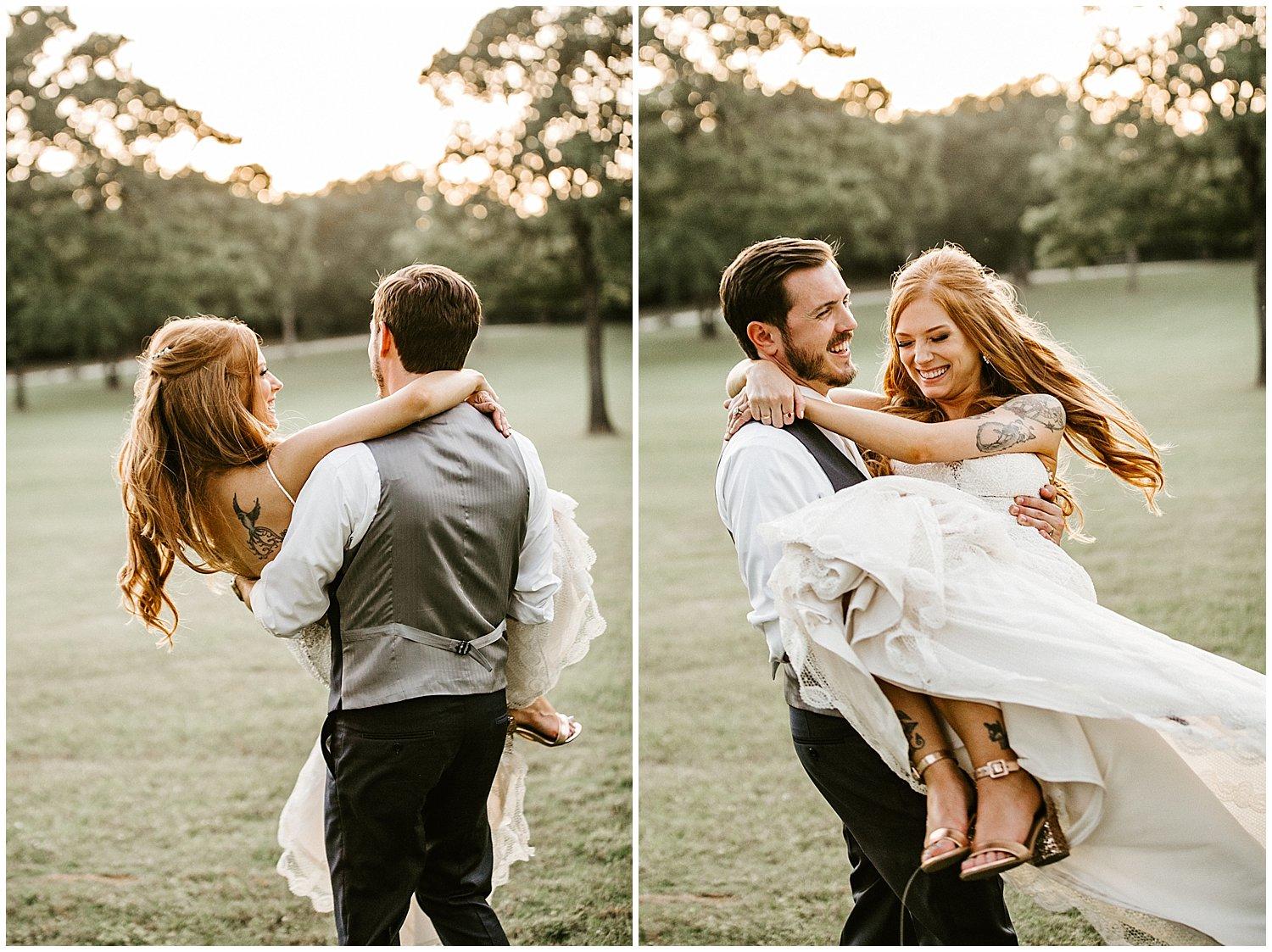 grooms swinging his bride around in his arms on green grass at sunset