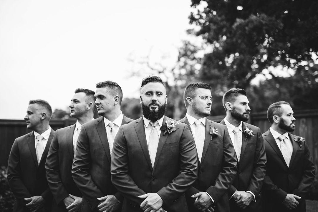 black and white photo of groom and groomsmen with serious faces