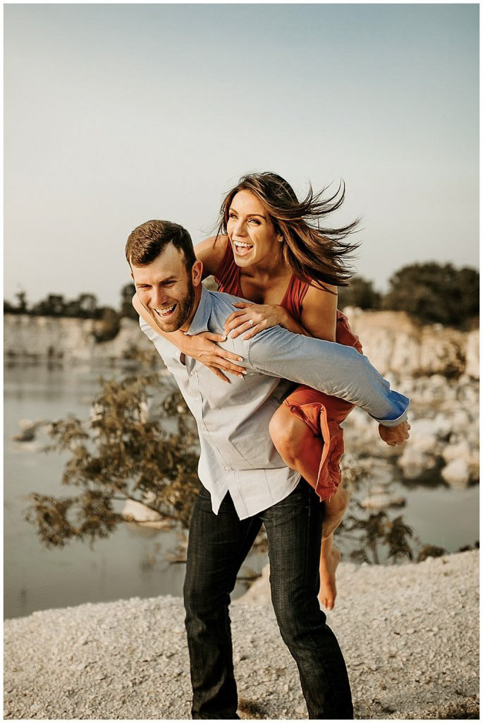 a fun couple portrait where the bride to be is on the back of the groom