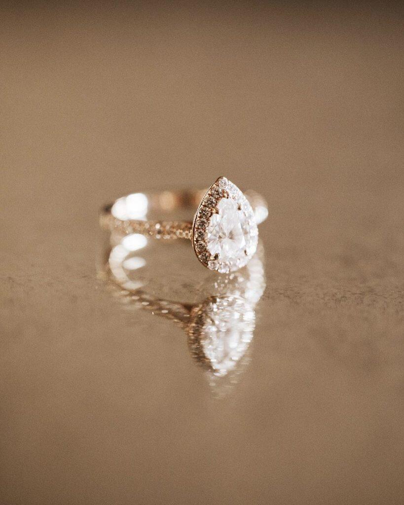 a close up shot of a pear-shaped wedding ring