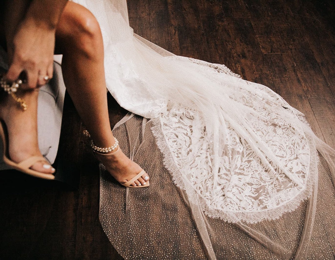 Close up shot of a bride wearing her wedding day shoes