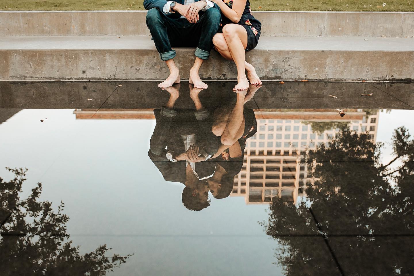 Reflection of a couple kissing while sitting at the stairs