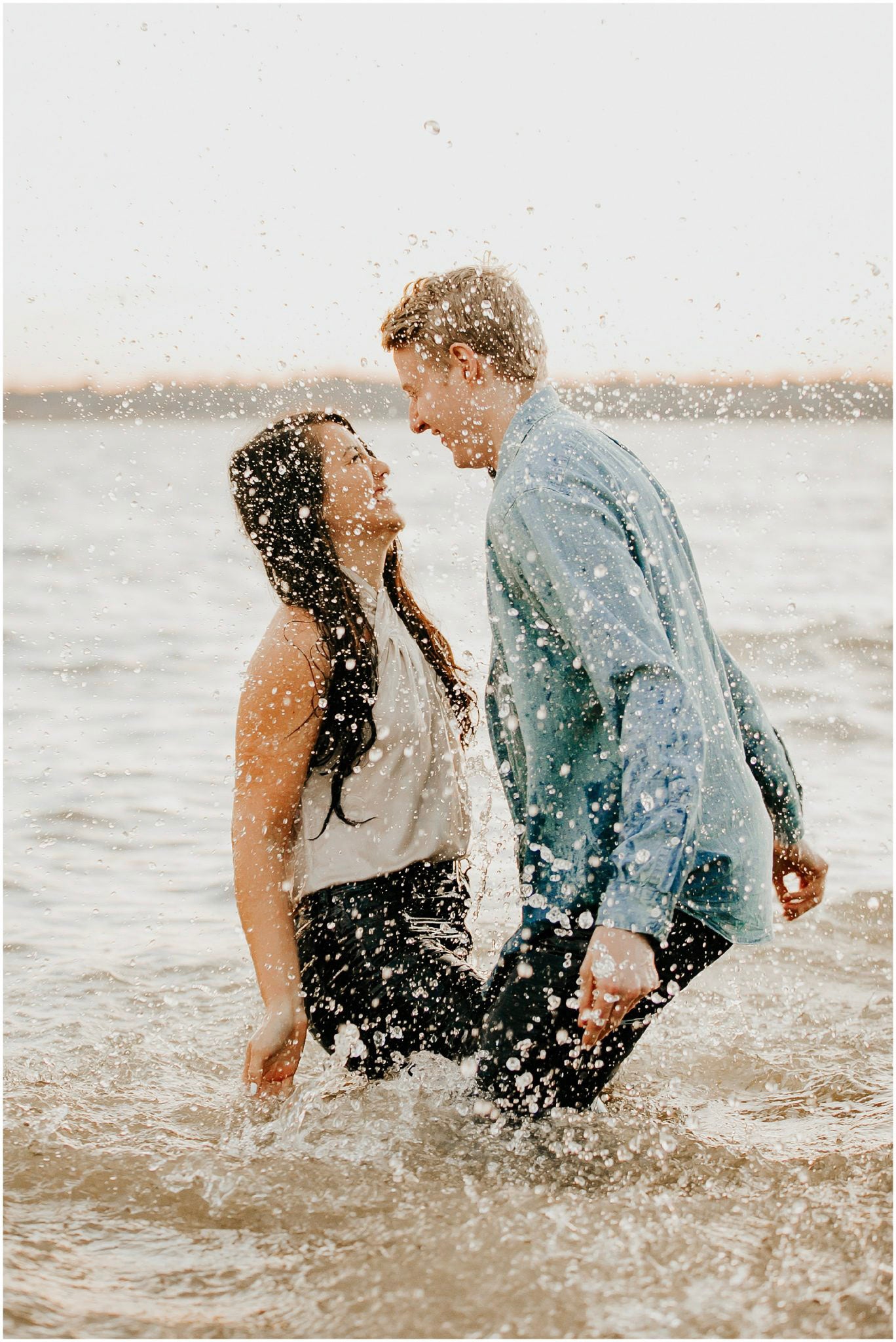 a couple having fun dancing in the sea 