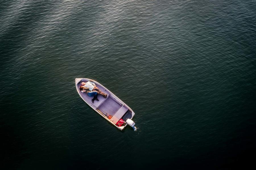 Drone photograph of a couple posing on a boat