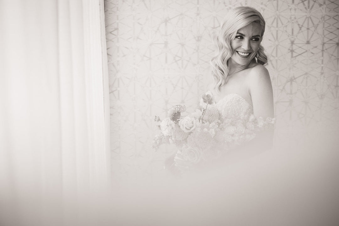 Bride holding a bouquet while posing for a solo bridal portrait