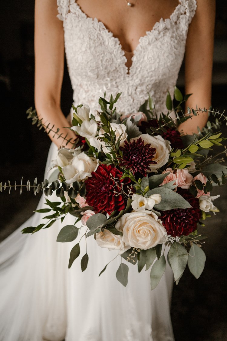 A close up of a bride holding a bridal bouquet