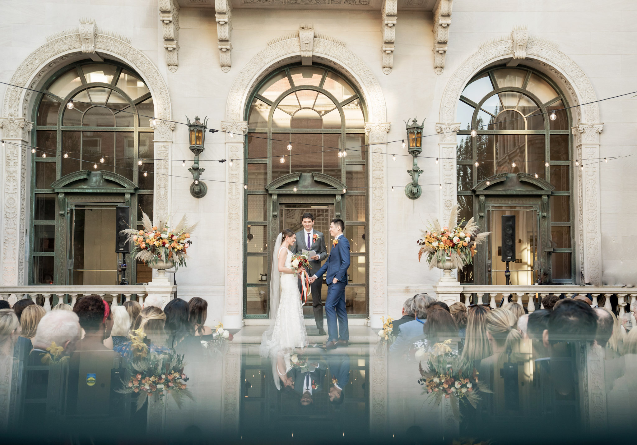 a bride and a groom is getting married in front of guests