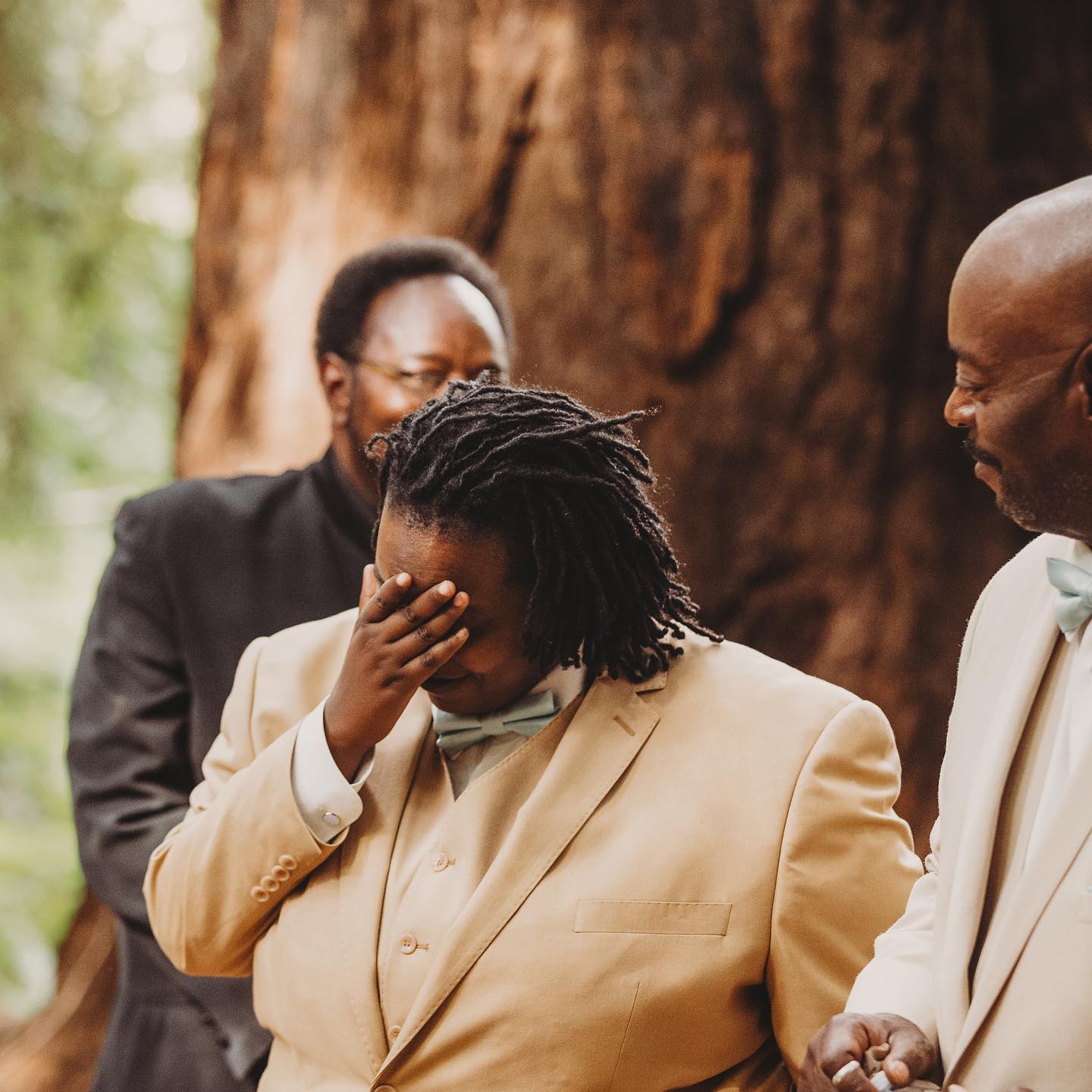 A portrait of a person of color getting emotional at a wedding