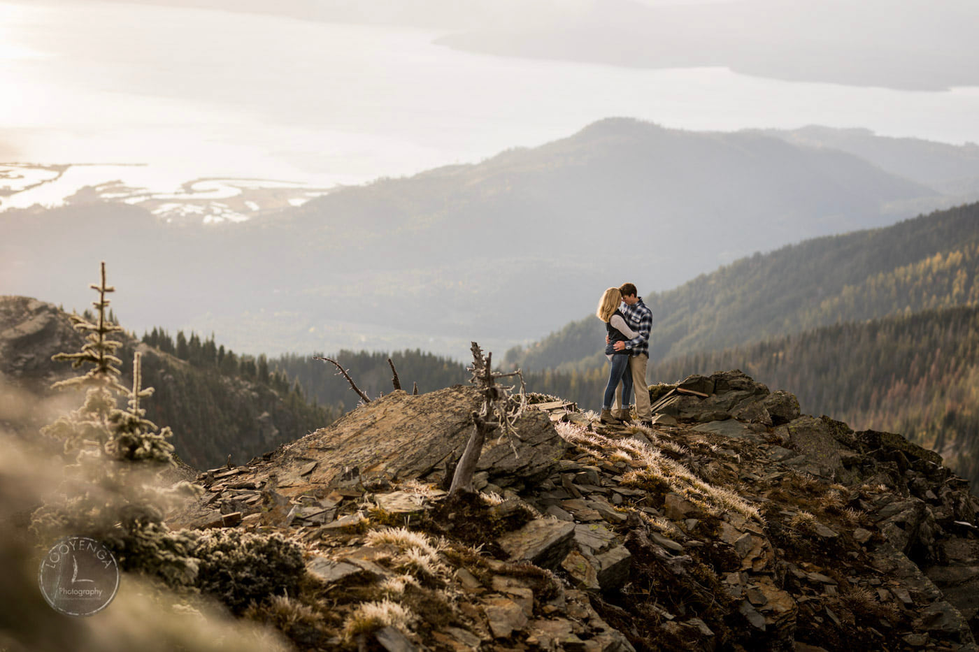 a couple holding each other in a hilly landscape