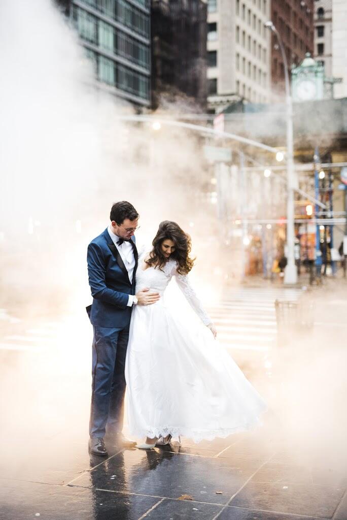 Apollo Fields New York City City Hall Elopement couple standing over subway grate in rain