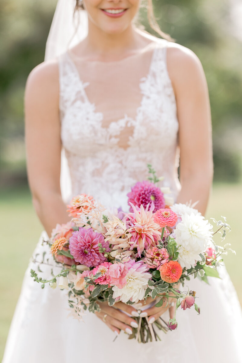 a creatively cropped image of a wedding bride with her wedding bouquet in her wedding dress