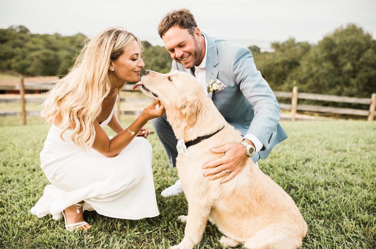 a wedding couple caressing their pet before the wedding