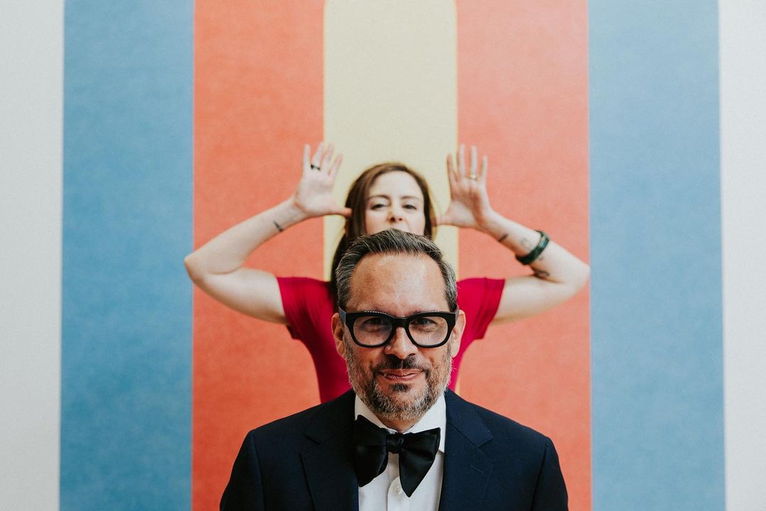 a wedding couple posing while the bride is making funny faces