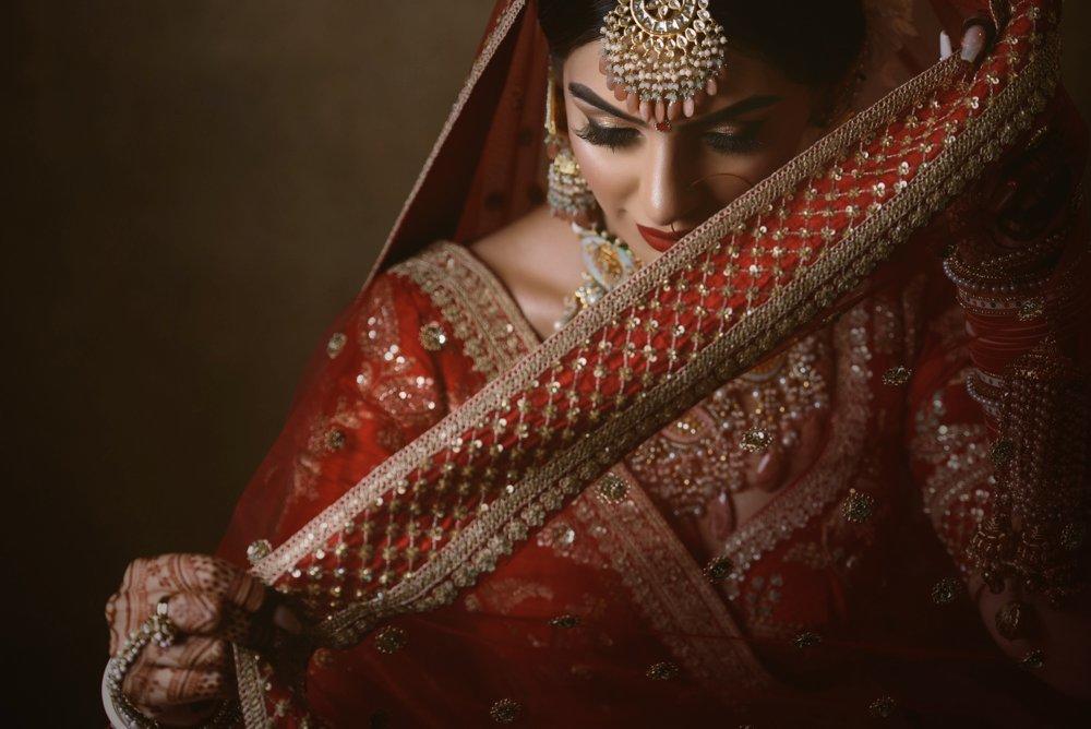 A beautiful portrait shot of a bride in an Indian wedding dress