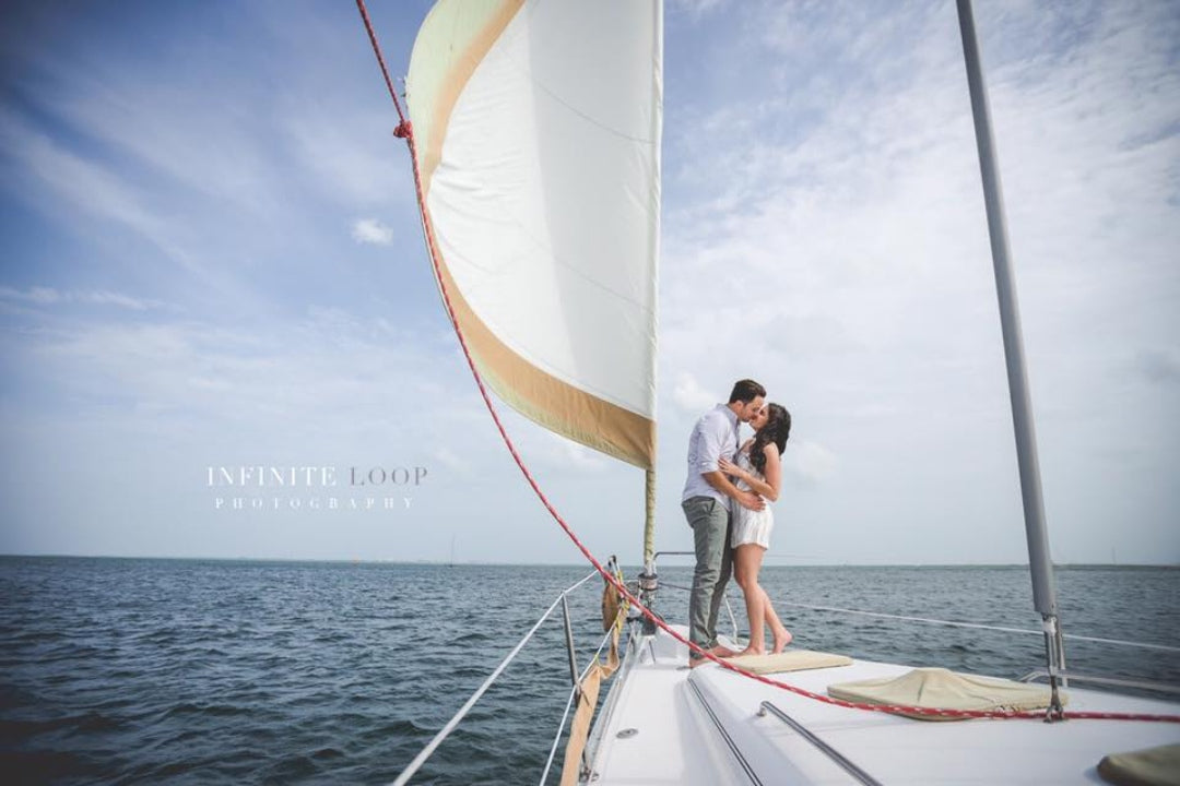 A couple posing on a yatch during an engagement session