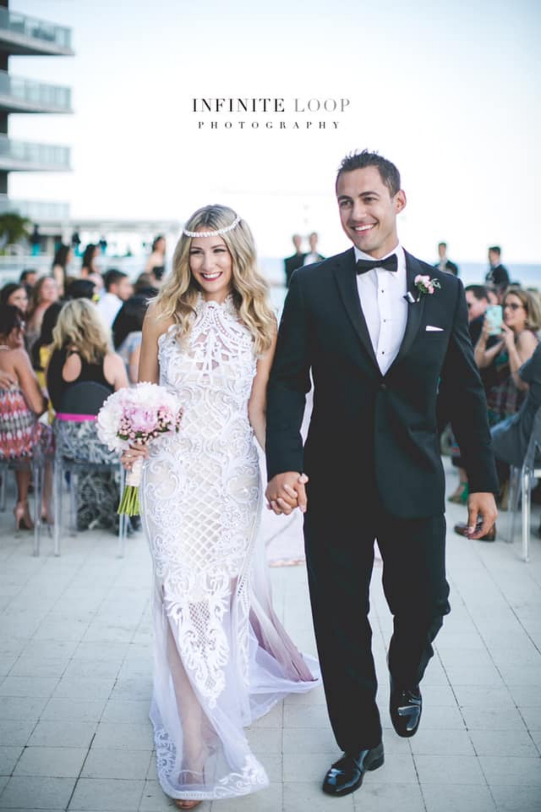 A bride and groom walking down the aisle hand in hand