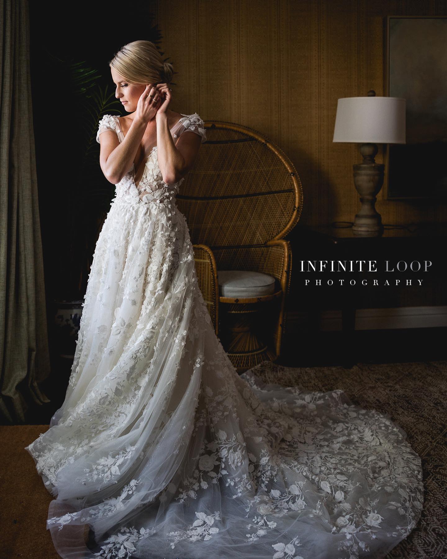 Portrait of a bride standing in front of a window wearing an earring