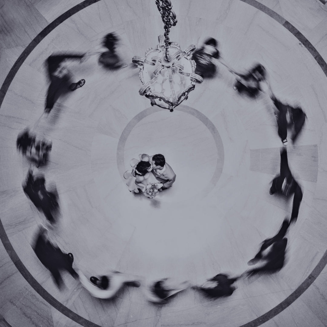 Aerial shot of a couple's first dance as the guests surround them in a circle 